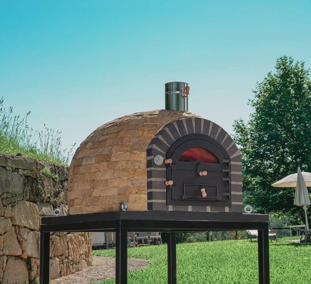Tevira wood-fired pizza oven with elegant Champagne Stone finish, ideal for outdoor cooking and garden entertaining.